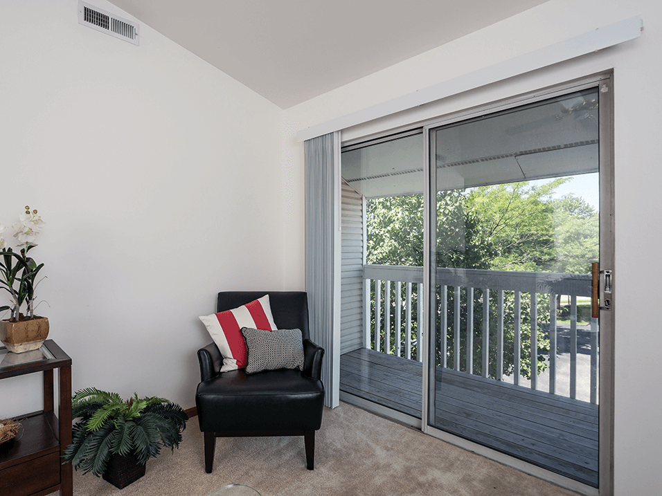 apartment living room with a sliding glass door to balcony