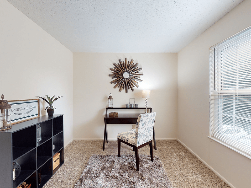 a bedroom with a desk and chair