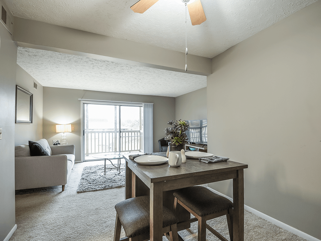 an open living room and dining room with a table and chairs