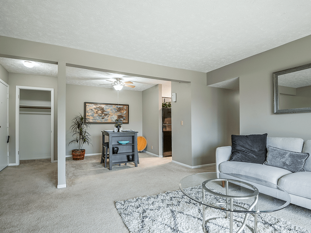 a living room with a couch and a glass coffee table