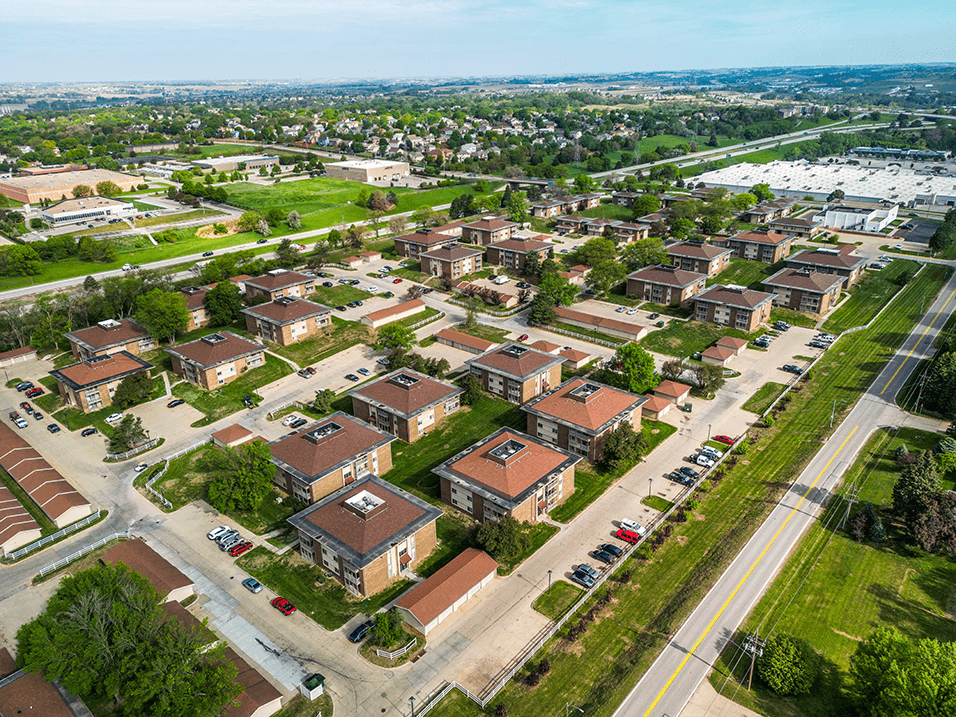 arial view of a neighborhood with brick houses and green grass