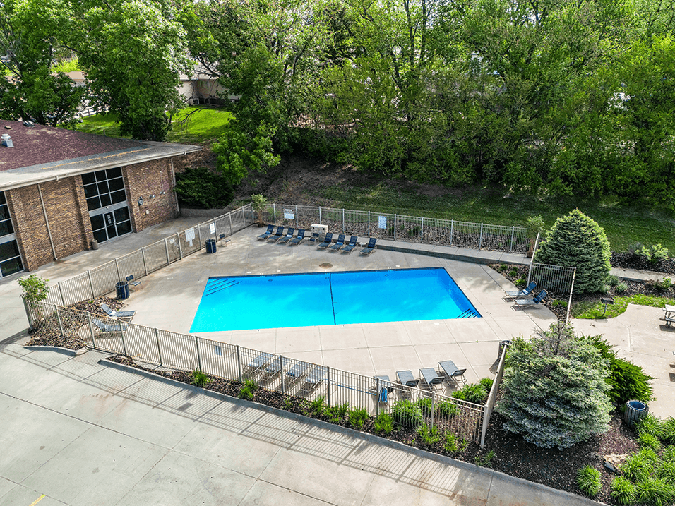 an aerial view of a swimming pool with a building