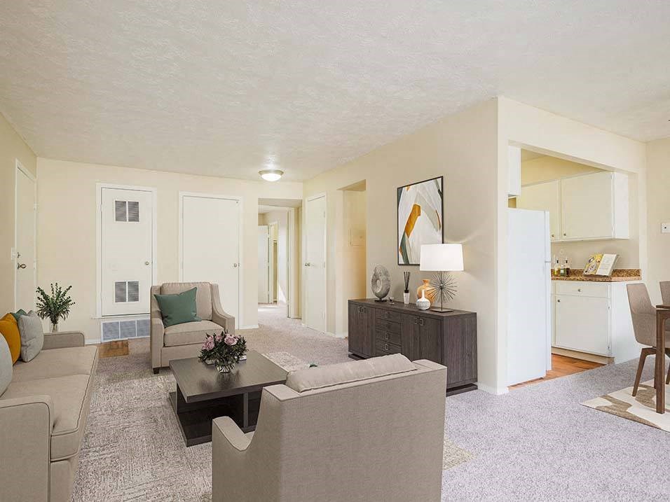 apartment living room with connected dining and kitchen area