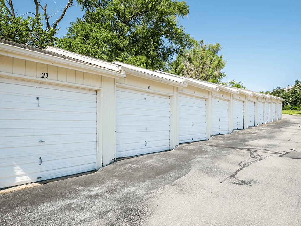 a row of white garages with white doors