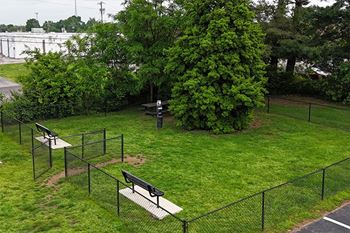A park with a swing set and a bench.