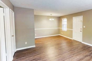 A room with wooden floors and white walls.