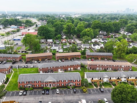 A large building complex with a parking lot in front.