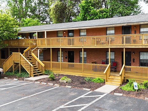 A building with a red brick exterior and a wooden balcony.