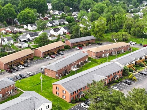 A large building complex with a parking lot in front.