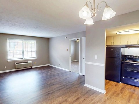 Kitchen with black appliances and open living room