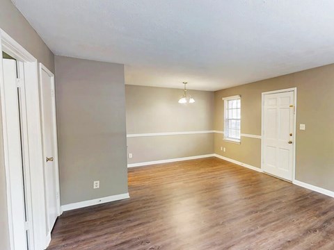 A room with wooden floors and white doors.