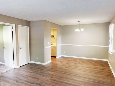 A room with wooden floors and a chandelier.