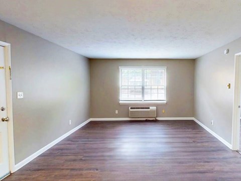 A room with a window and a heater.