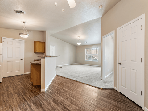 A room with a wooden floor and white walls.