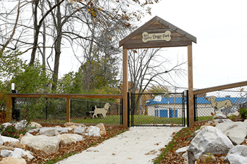 a dog park with a fence and a gated entrance