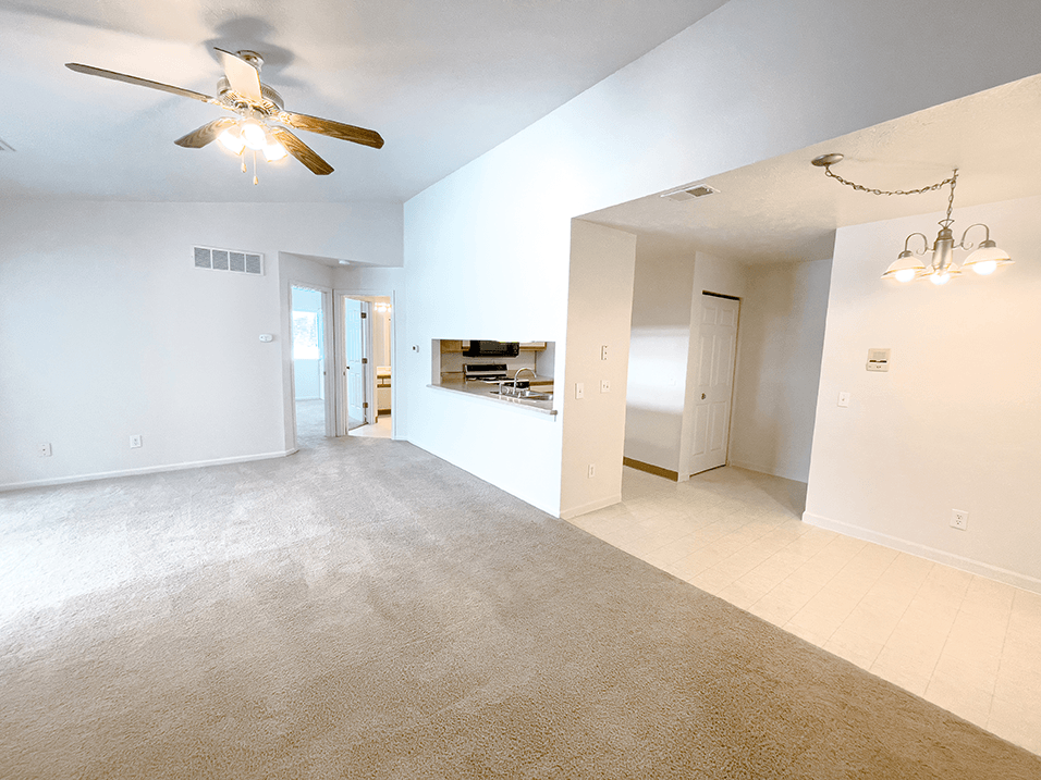 a living and dining room with overhead lighting
