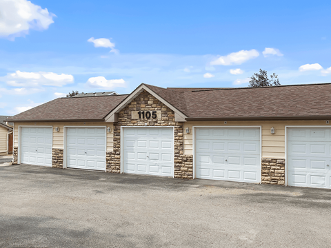 A building with the number 1105 on it has four garage doors.