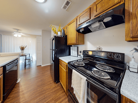 a kitchen with black appliances and wooden cabinets