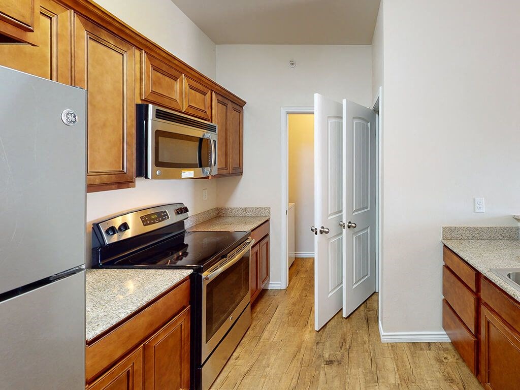 a kitchen with a stove and a refrigerator