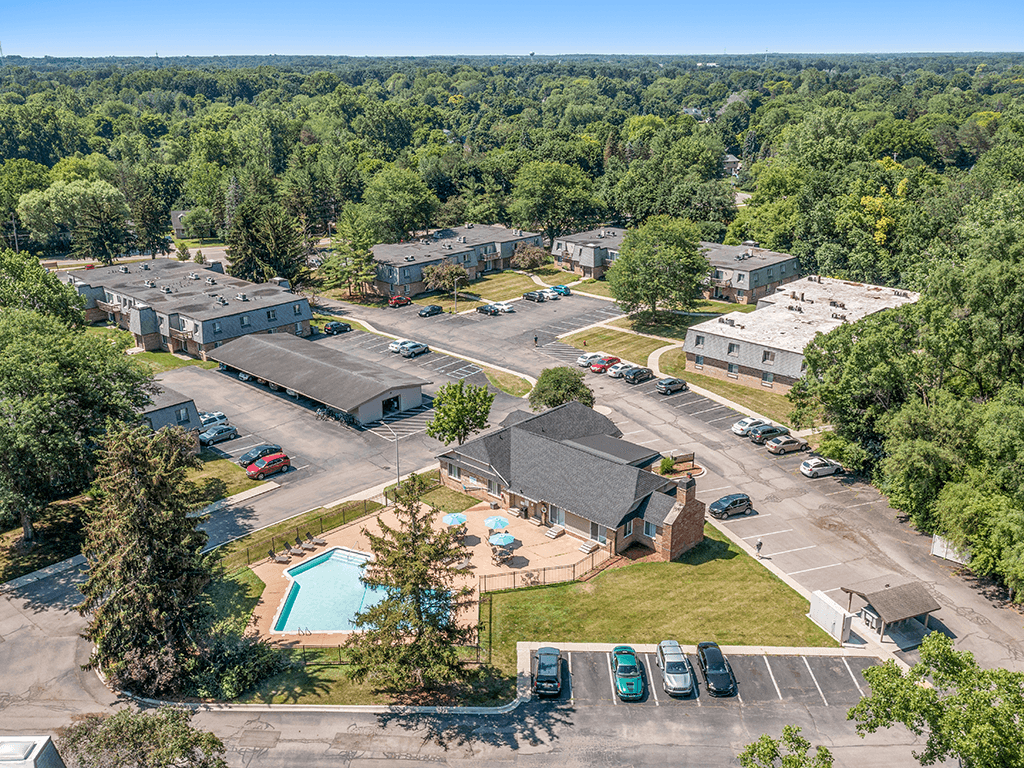 A bird's eye view of a residential complex with a swimming pool.
