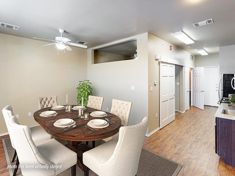 A dining room with a round table set for six.