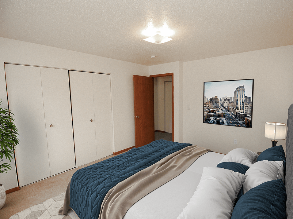 a bedroom with a large bed and closets