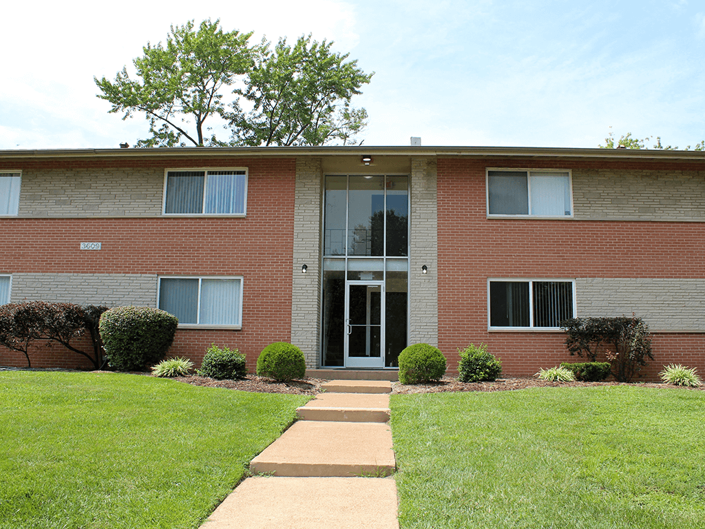 a brick building with a lawn in front of it