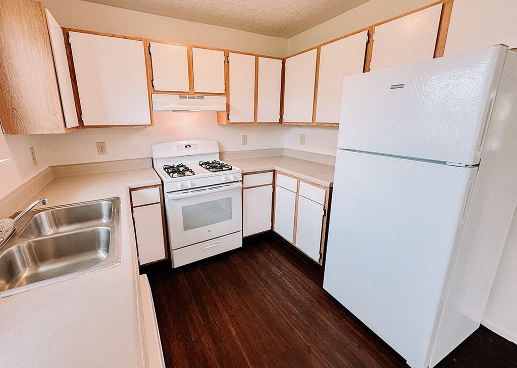 a kitchen with white appliances and white cabinets