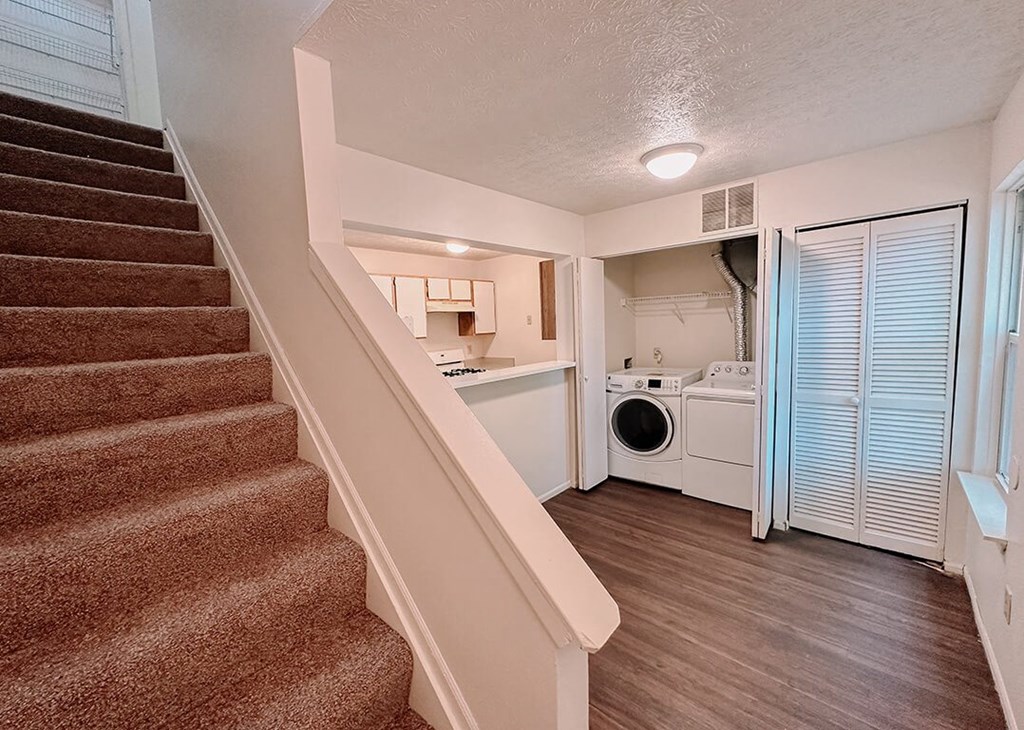 a view of a staircase and a laundry room in a home