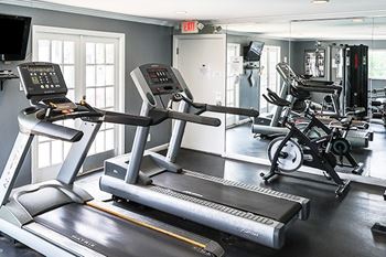 A gym with treadmills and exercise bikes.