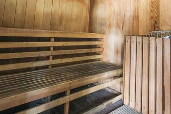 A sauna with wooden benches and walls.