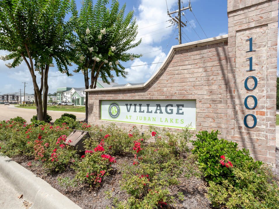 welcome sign at Village at Juban Lakes Apartments
