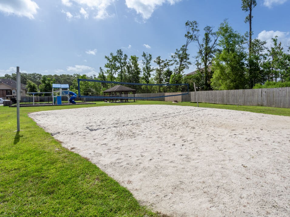 apartment complex with sand volleyball court