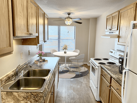 a kitchen with a sink and a table with a chair
