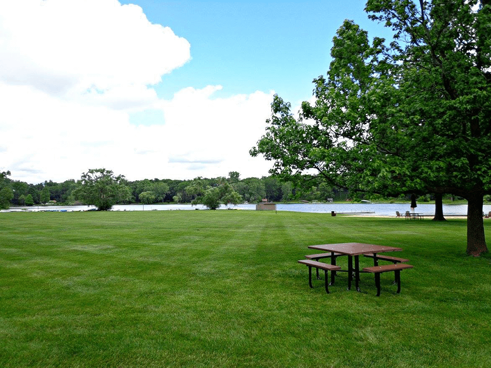 picnic area along side lamberton lake in grand rapids at Lamberton Lake Apartments 