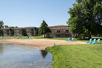 a beach in front of lamberton lake apartments