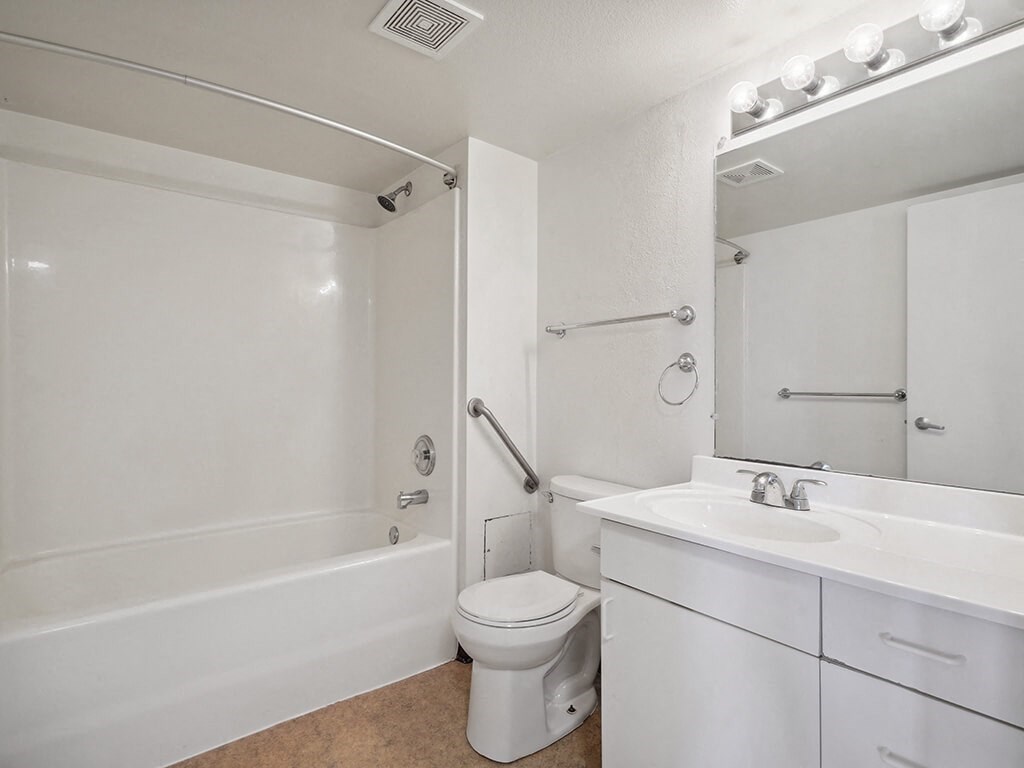 a bathroom with a sink toilet and a bath tub