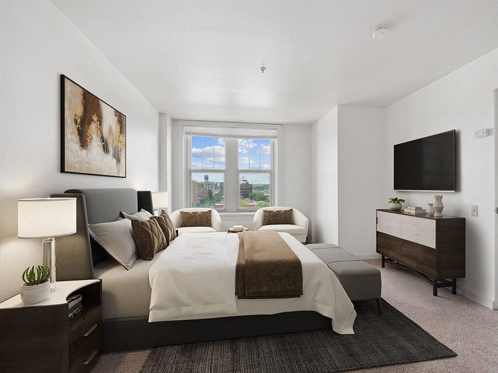 a bedroom with a large bed and window