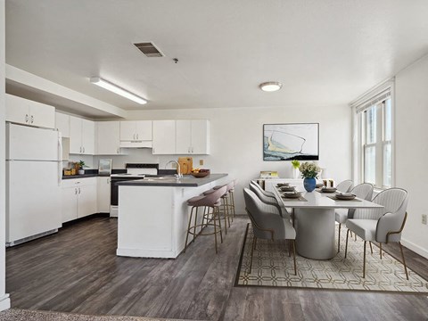 a kitchen and dining room with a table and chairs