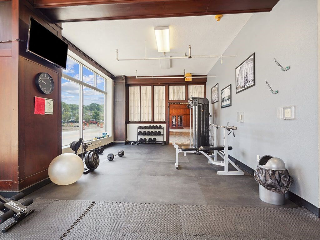 a workout room with weights and a window