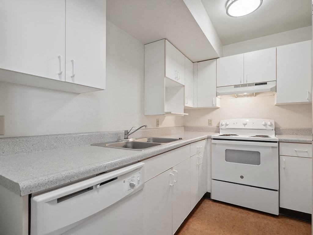 kitchen with white appliances and Granite-Style Countertops