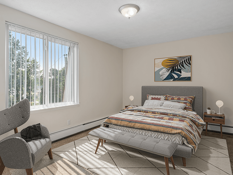 a bedroom with a bed and two windows