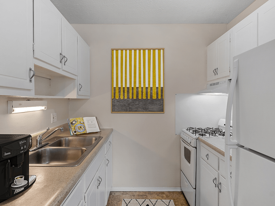 a kitchen with white cabinets and white appliances