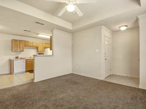 A room with a ceiling fan and a washing machine.