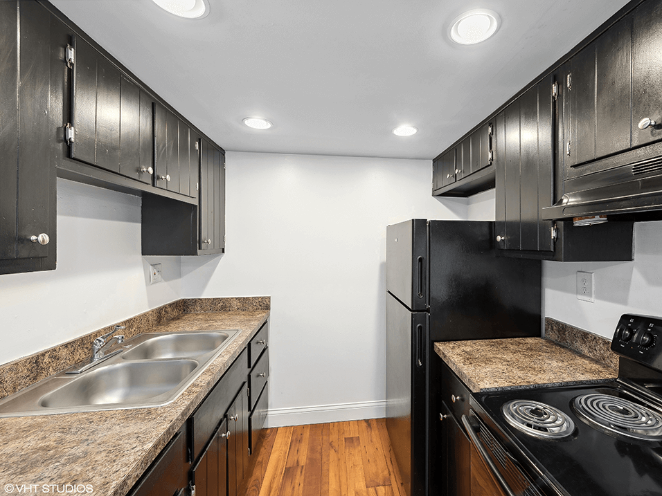 a kitchen with black appliances and granite counter tops