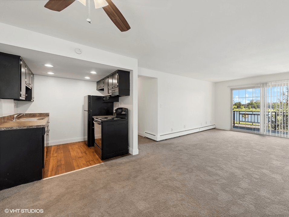 living room with a kitchen and a balcony