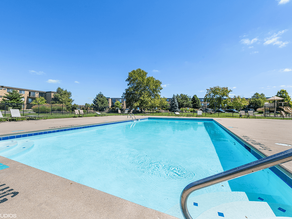 swimming pool with apartment buildings in the background