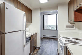 A kitchen with a white refrigerator and a stove top oven.
