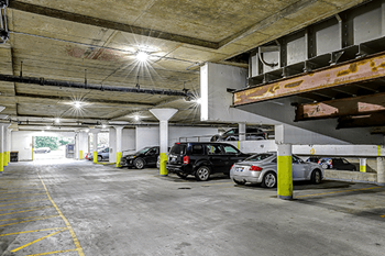 A parking garage with cars parked in it.