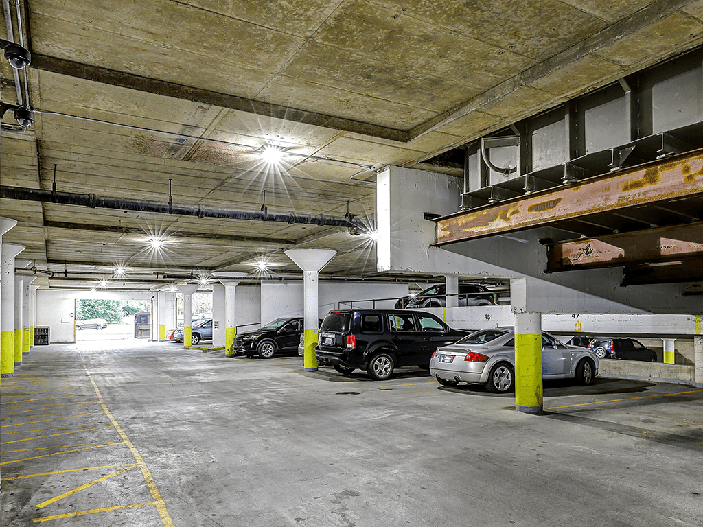 A parking garage with cars parked in it.